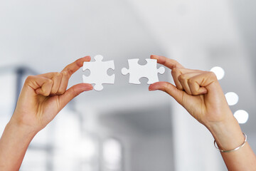 Business person, hands and jigsaw puzzle with pieces for strategy or problem solving at office....