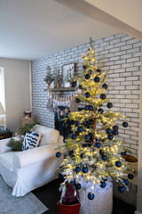 Holiday Christmas Tree in a Colonial style living room with a fireplace in the background