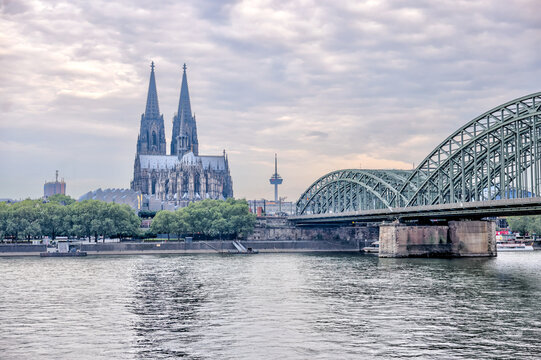 Koln, Germany - July 31, 2024: The Hohenzollern Bridge and Cathedral at sunrise in Cologne, Germany
