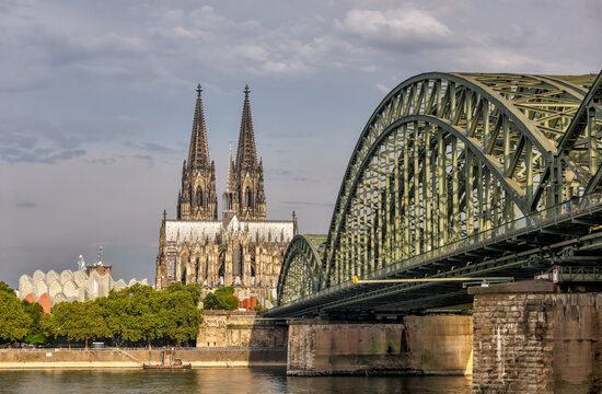 Koln, Germany - July 31, 2024: The Hohenzollern Bridge and Cathedral at sunrise in Cologne, Germany
