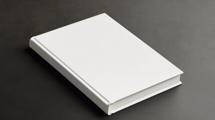 Blank book cover on a dark surface, ideal for mockups and design projects.