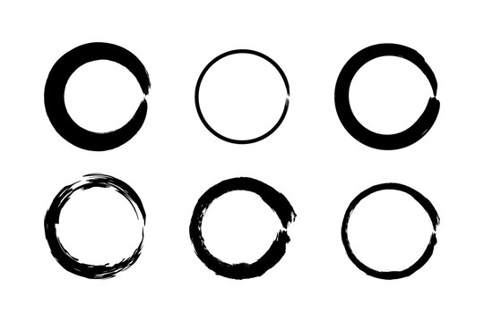 Set of hand-drawn circle ink brush strokes symbolizing the Zen enso in Japanese calligraphy. Abstract design with rough edges and grainy chalk texture.
