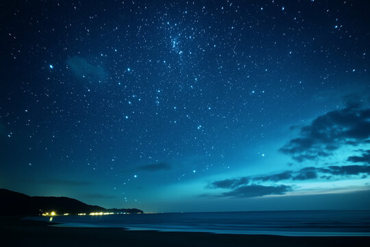 Starry night sky with clouds over a beach, night sky with stars and clouds
