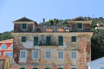 Facade of an Abandoned Old Town Building on a Greek Island: Timeworn Architecture and Faded Charm