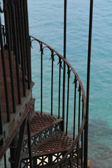 Rustic Metal Gazebo with Rusty Spiral Stairs Leading Toward the Sea, Surrounded by Greek Island Landscape