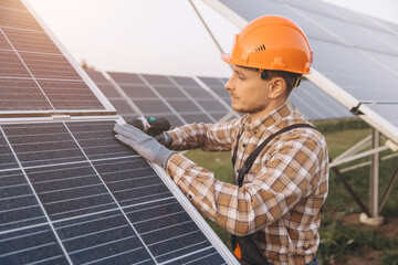 Engineer Installing Solar Panels Outdoors At a Solar Farm