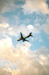 big european airplane flying for people against blue sky with clouds in the afternoon on summer day