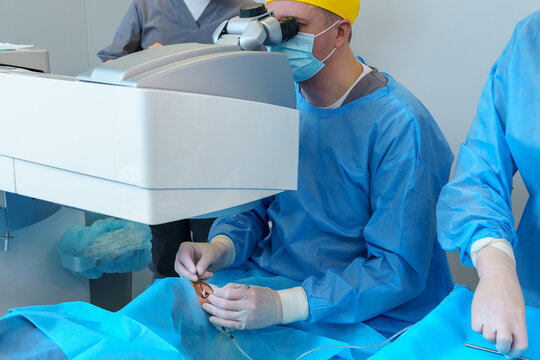 Surgeon Utilizing Microscope for Precise Eye Surgery