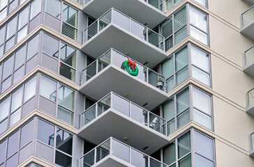 Corner of a residential high-rise building with balconies decorated for Christmas