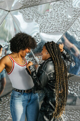 Two girls dancing and having fun in the city