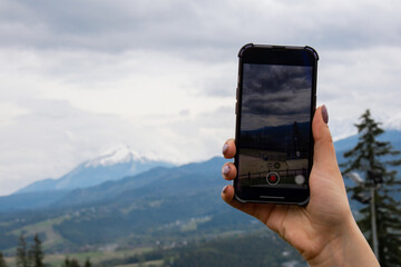 Mobile phone shooting video for social media. Tourist blogger travel hand making memories Snowy...