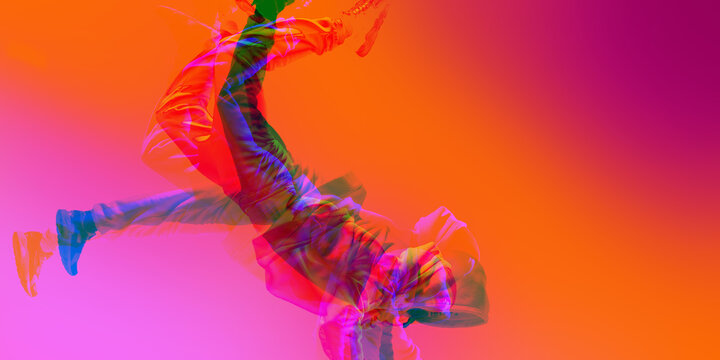 Street dancer leaping mid-air, dancing hip hop, freestyle, with overlays of pink, orange, and red hues. Energy of hip-hop culture. Contemporary art collage. Concept of art, dance