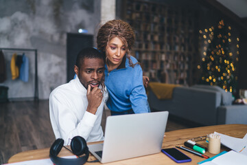 Worried African American man and woman intensely looking at laptop screen, displaying concern and focus. They examining what appears to be critical or unexpected information