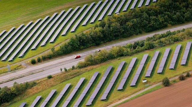 Solar panels alongside a highway in Germany. Aerial view.