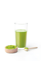Glass with fresh wheatgrass juice isolated on white background vertical photo