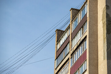 A tall building with a lot of windows and a red brick facade