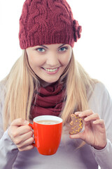 Woman in cap and shawl holding gingerbreads and cup of tea