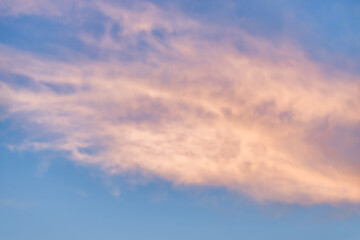 A beautiful sky tinted by the sun leaving vibrant shades of gold, pink, blue and multicolored. Clouds in the twilight evening and morning sky. Cloudy sky background in the evening, and during the day.