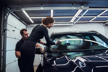 Team Effort In Car Windshield Cleaning