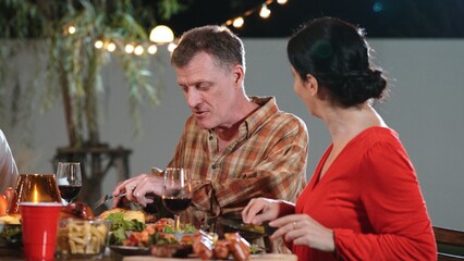 Family together for holiday celebration in garden. Old romantic senior drink wine have dinner. Outdoor camping activity, celebrate and spend time with lovely couple strengthen family bond. Divergence.