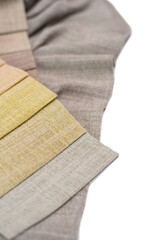 Samples of textured linen fabric for curtains in warm colors on a white background.