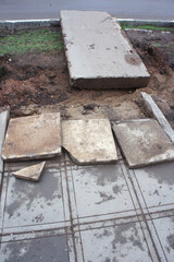 Repair of concrete tiles. Pedestrian and dismantling area renovation. Broken concrete slabs coating. Laying new tiles on sidewalk. Work to rebuild outside area renovation. Comfortable Urban environmen