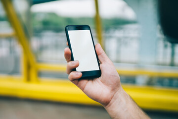 Faceless male browsing phone chilling in city