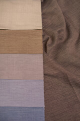 Fabric samples for curtains in beige, brown and blue colors. Fabric for interior decoration