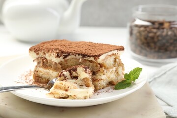Piece of tasty tiramisu on table, closeup