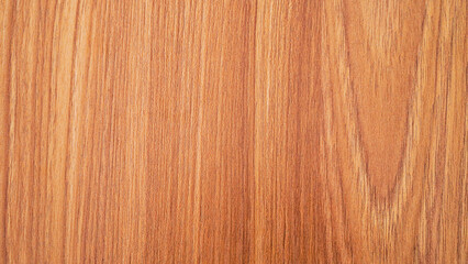 Naklejka premium A close-up of a wooden surface, showcasing the intricate grain patterns and warm, brown hues. The texture and detail of the wood create a natural and rustic aesthetic.