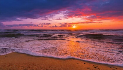 Obraz premium Waves on the beach at red sunset