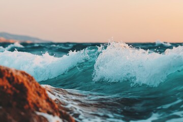Fototapeta premium A serene seascape featuring rolling waves crashing against rocks during sunset. A perfect capture of nature's beauty and tranquility.