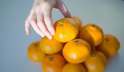 Oranges with Child s Hand Placing Orange on Top