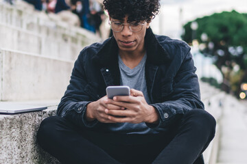 African American man using smartphone outdoors