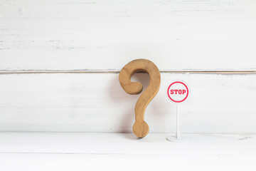 Hesitation Ahead: Wooden Question Mark with a Small Stop Sign