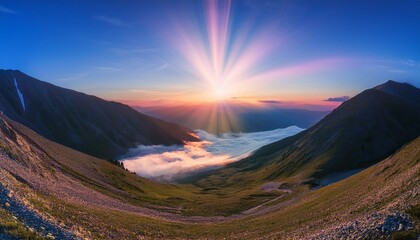 Waves of light in the mountain valley stretch into the sky