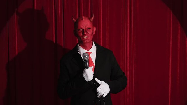 Devilish comedian performing stand up comedy routine