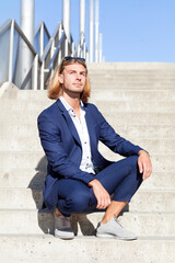 Handsome Young Man in Blue Suit Posing Outdoors