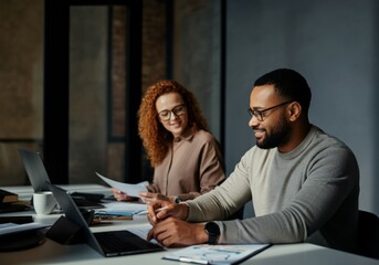 Focused and Concentrated Business Partners Working Together at a Desk