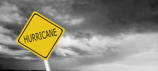 danger,caution,Hurricane Idalia warning sign against a powerful stormy background with copy space. Dirty and angled sign with cyclonic winds add to the drama.hurricane season sign on cloudy background