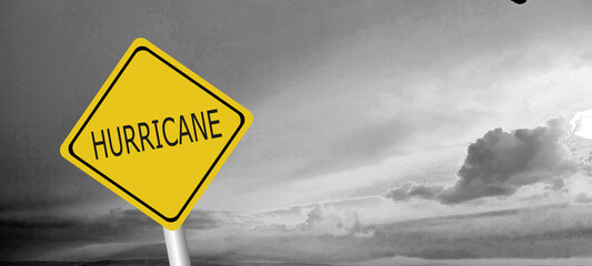 danger,caution,Hurricane Idalia warning sign against a powerful stormy background with copy space. Dirty and angled sign with cyclonic winds add to the drama.hurricane season sign on cloudy background