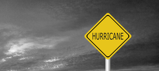 danger,caution,Hurricane Idalia warning sign against a powerful stormy background with copy space. Dirty and angled sign with cyclonic winds add to the drama.hurricane season sign on cloudy background