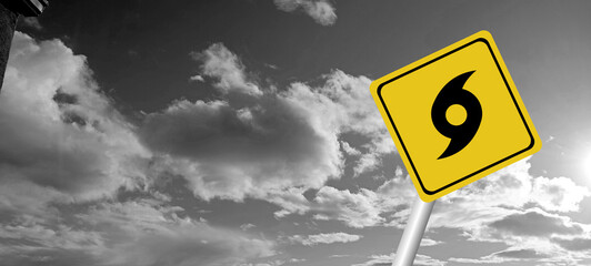danger,caution,Hurricane Idalia warning sign against a powerful stormy background with copy space. Dirty and angled sign with cyclonic winds add to the drama.hurricane season sign on cloudy background