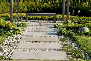 Path leading to a bench in a gazebo in a Japanese garden