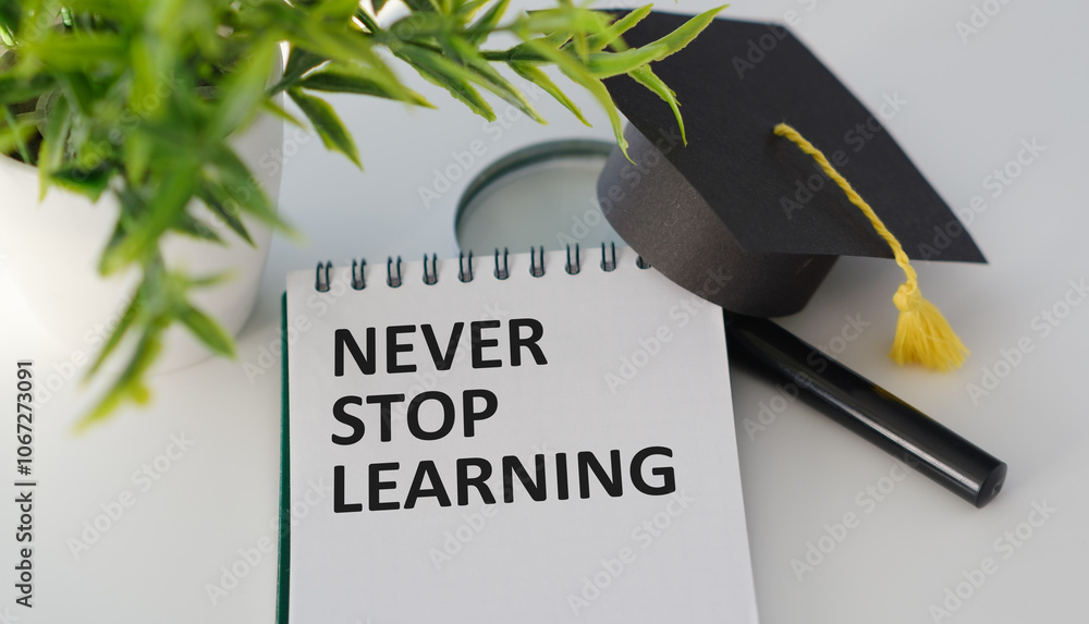 Fototapete notebook page with text never stop learning in the middle of wooden cubes with letters