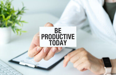 Be Productive Today inscription on a notepad in hand on a light background