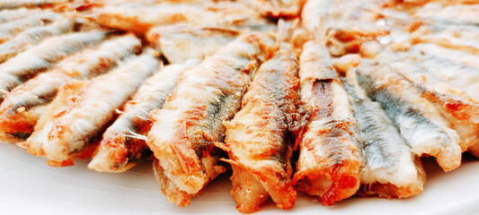 fried anchovies in a frying pan, fried anchovies (TURKEY anchovies), anchovy fish, fried anchovies in a salad plate, collage from different photos of delicious seafood