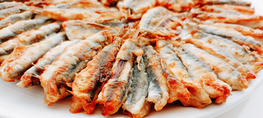 fried anchovies in a frying pan, fried anchovies (TURKEY anchovies), anchovy fish, fried anchovies in a salad plate, collage from different photos of delicious seafood