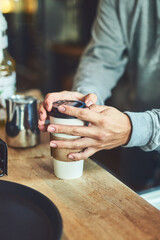 Hands, cafe and person with takeaway coffee in morning with lid for beverage sale in restaurant. Drink, paper container and closeup of customer with caffeine latte, cappuccino or espresso in store.