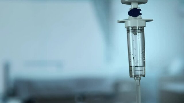 Dripping saline, Dripping medical perfusion close up equipment in clinic background, Medical equipment, Saline Solution IV Drip Fluid for Infusion in Hospital. Intravenous drip in operation room.